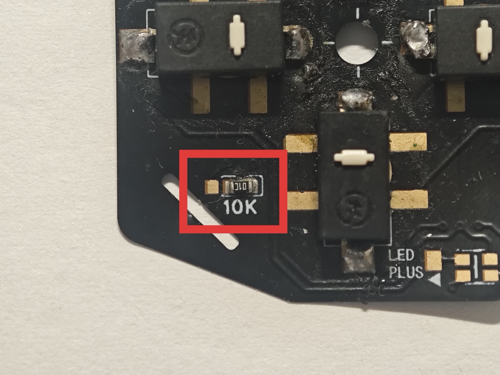 HML FPC close-up. The red box marks a resistor labeled 10K and a separate pad to its left. Connect the left pad to the resistor's left terminal.